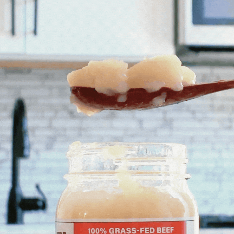 Spoonful of Reclamation Korean-Style Beef Bone Broth jiggling on spoon in front of kitchen counter