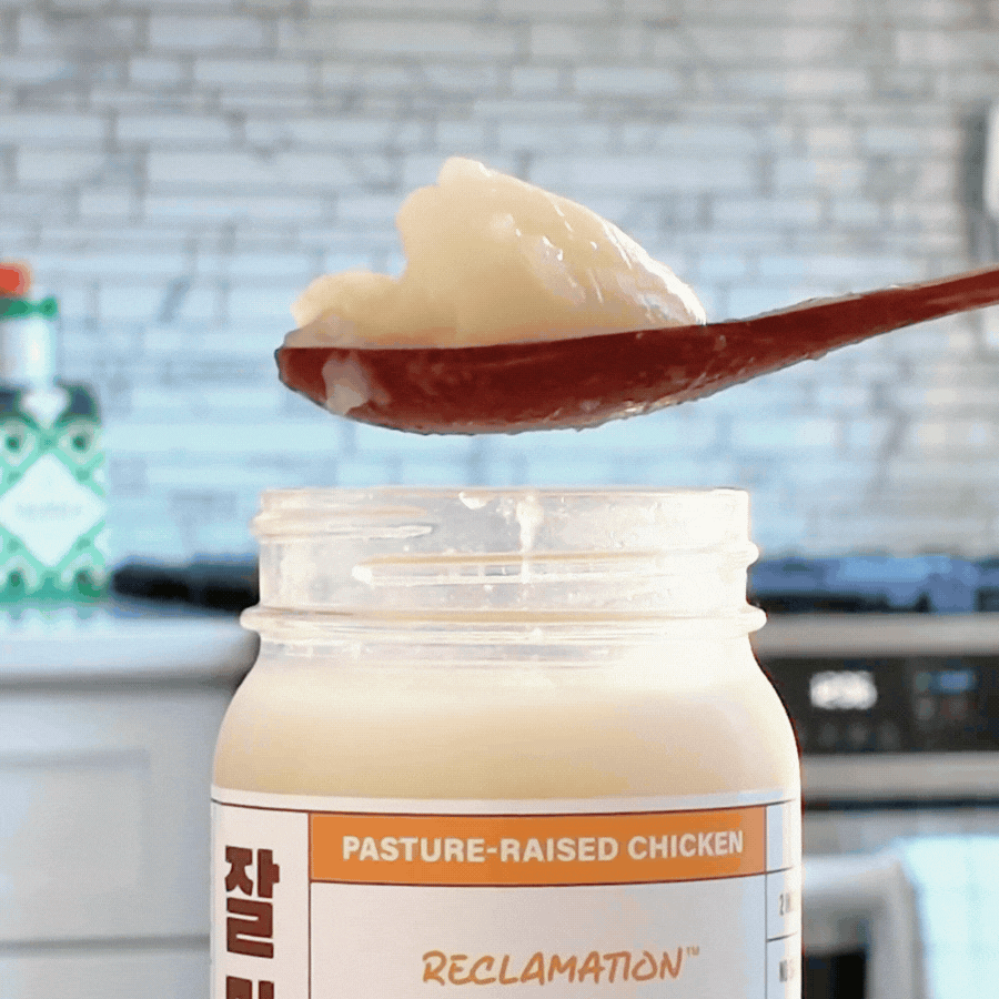 Spoonful of Reclamation Korean-Style Chicken Bone Broth jiggling on spoon in front of kitchen counter