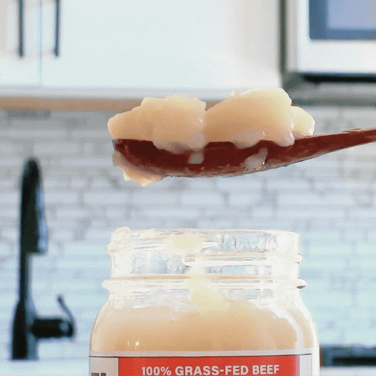 Spoonful of Reclamation Korean-Style Beef Bone Broth jiggling on spoon in front of kitchen counter